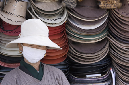 Woman with mask and hats 2- Barkor Market Lhasa Tibet