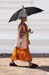 Monk with umbrella at Phra Pathom Chedi Thailand